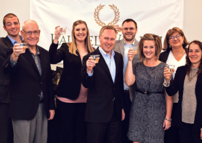 Laurel Wealth Planning team raising glasses at 20th anniversary party