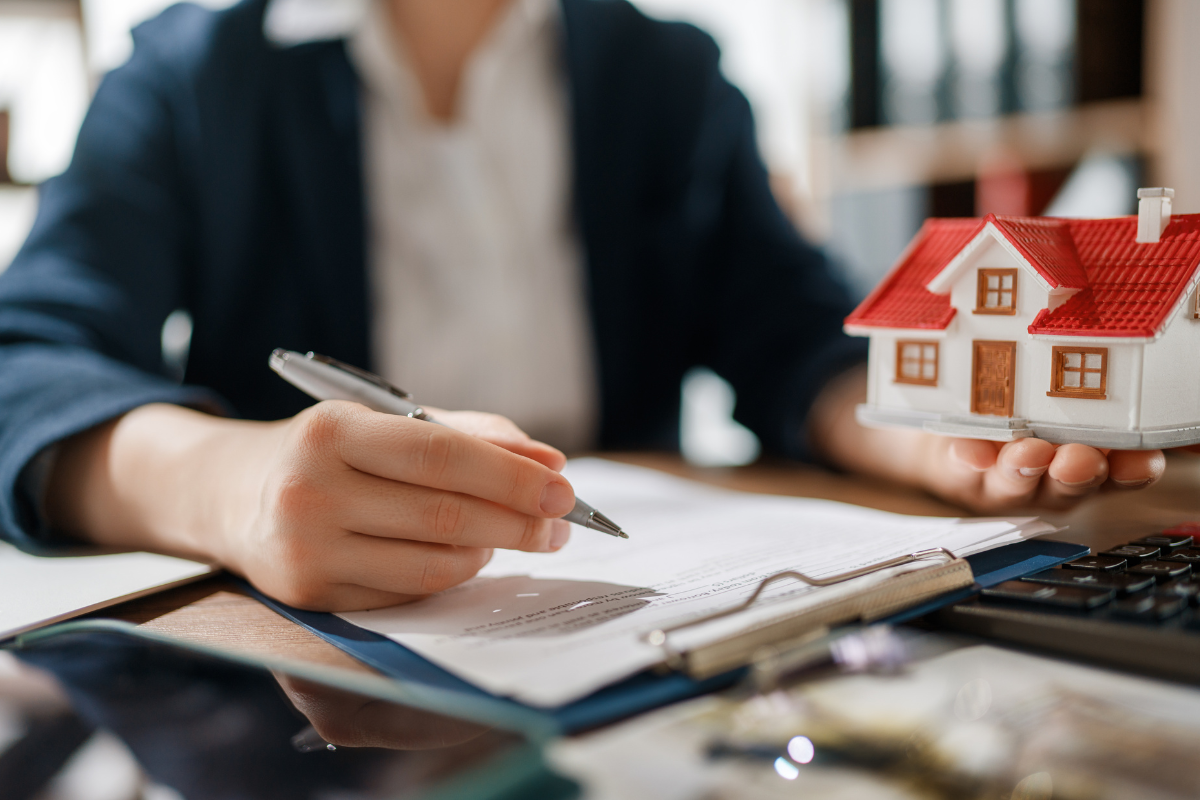 Financial planning documents, account statements, and a pen on a desk, representing how to align account ownership and beneficiary designations with an estate plan.